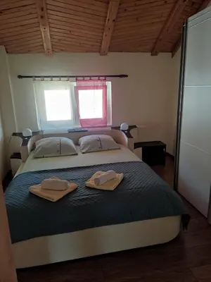a bedroom with a bed with two towels on it at Guesthouse Nestoria Living in Banja Luka
