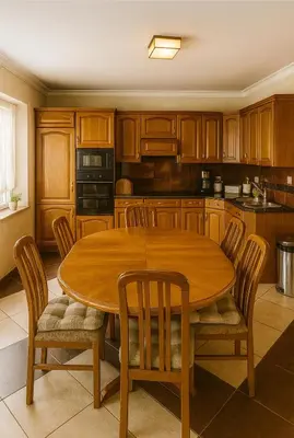 a kitchen with a wooden table and chairs at Guesthouse Nestoria Living in Banja Luka