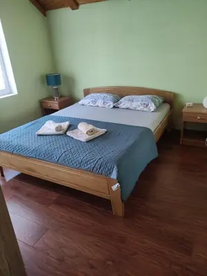 a bedroom with a bed with towels on it at Guesthouse Nestoria Living in Banja Luka