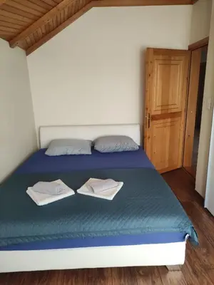 a bedroom with a bed with two towels on it at Guesthouse Nestoria Living in Banja Luka