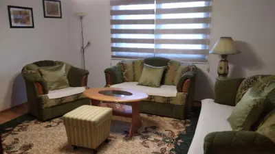 a living room with two couches and a table at Comfort house near pyramides in Visoko