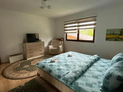 a bedroom with a bed and a dresser and a window at Comfort house near pyramides in Visoko
