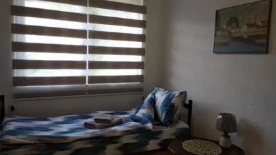 a small bed in a bedroom with a window at Comfort house near pyramides in Visoko