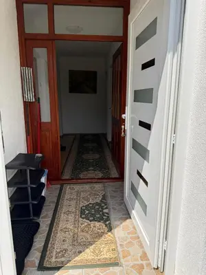 a hallway with a door and a tile floor at Comfort house near pyramides in Visoko