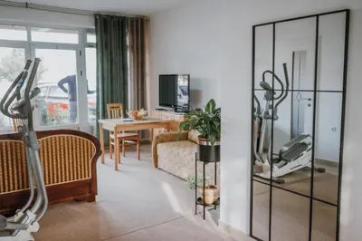 a living room with a room with a gym at MASAL Studio Apartman in Bihać