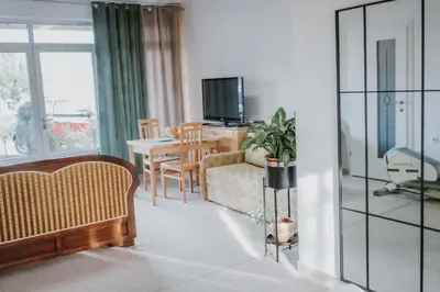 a living room with a couch and a table with a tv at MASAL Studio Apartman in Bihać