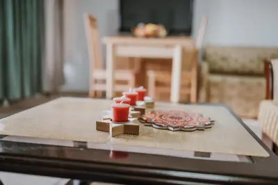 a table with a tray with red candles on it at MASAL Studio Apartman in Bihać