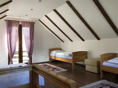 a bedroom with two beds and a window at Vikendice - Vodenica Jurić in Prozor