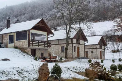 a large house with snow on the ground at Vikendice - Vodenica Jurić in Prozor