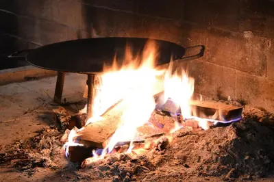 a pan sitting on top of a fire at Vikendice - Vodenica Jurić in Prozor