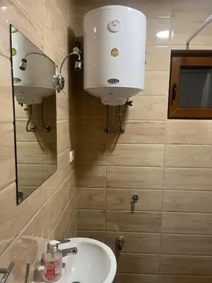 a bathroom with a sink and a water tank at Vikendice - Vodenica Jurić in Prozor