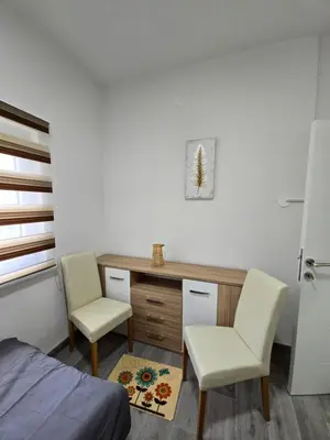 a bedroom with a desk and two chairs and a bed at Riverstone Retreat Villa in Jajce