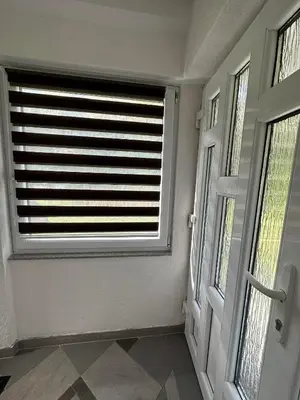 a room with a door and a window with blinds at Riverstone Retreat Villa in Jajce
