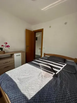 a bedroom with a bed with a blue and white comforter at Riverstone Retreat Villa in Jajce