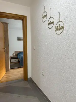 a hallway with a room with a bed and a mirror at Riverstone Retreat Villa in Jajce