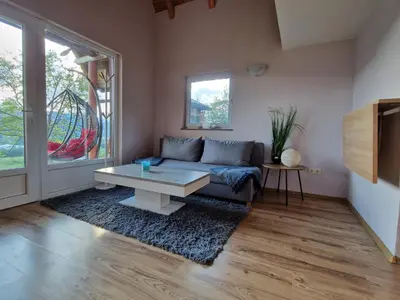 a living room with a couch and a coffee table at Weekend House Sunset in Zapoljak