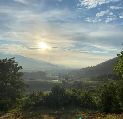 a view of a valley with the sun in the sky at Weekend House Sunset in Zapoljak
