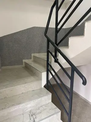 a staircase with a black metal railing next to some stairs at City centar Travnik-free parking in Travnik