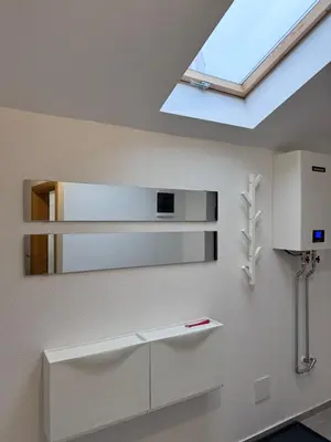 a bathroom with a mirror and a skylight at City centar Travnik-free parking in Travnik