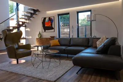 a living room with a couch and a table and chairs at Villa of Senses in Bihać