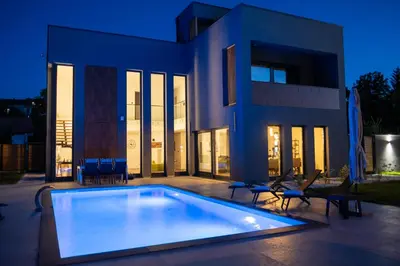 a large swimming pool in front of a house at Villa of Senses in Bihać