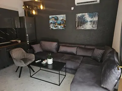 a living room with a couch and a table at Apartman Fin in Jajce