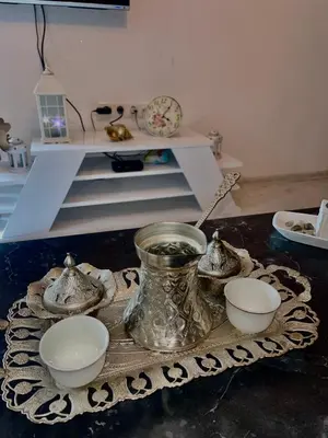a table with bowls and a vase on a table at Apartman Fin in Jajce
