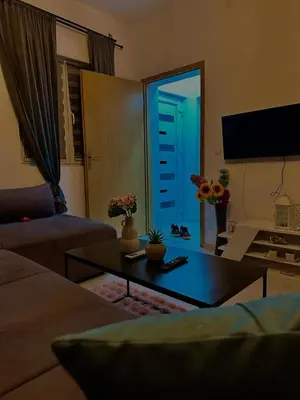 a living room with a couch and a table with a blue door at Apartman Fin in Jajce