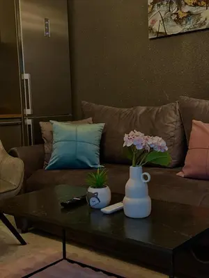 a living room with a couch and a table with flowers at Apartman Fin in Jajce