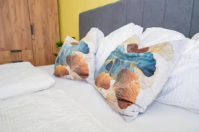 two pillows on a bed with at Palma in Jajce