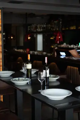 a table with two bottles of wine and glasses at CASA V BENCUN Deluxe Queen Rooms in Kiseljak