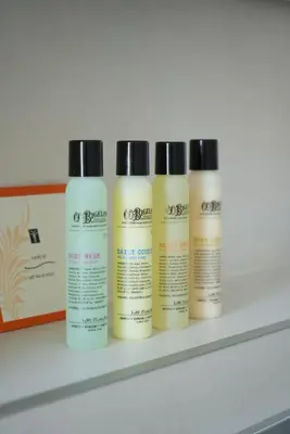 four bottles of sunscreen sitting on a shelf at CASA V BENCUN Deluxe Queen Rooms in Kiseljak
