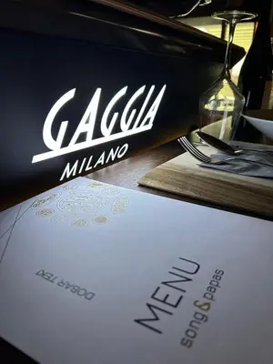 a sign for a restaurant on a table at CASA V BENCUN Deluxe Queen Rooms in Kiseljak