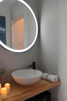 a bathroom with a white sink and a mirror at BLOK- Brick and wood cottage in Visoko