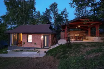 a small house with a porch and a patio at BLOK- Brick and wood cottage in Visoko