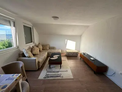 a living room with a couch and a table at Stan na dan Banjaluka in Banja Luka