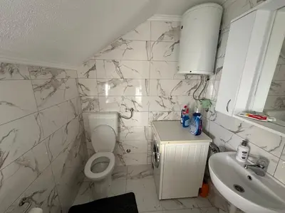 a bathroom with a toilet and a sink at Stan na dan Banjaluka in Banja Luka