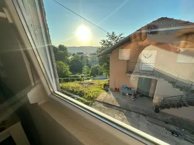 an open window with a view of a building at Stan na dan Banjaluka in Banja Luka