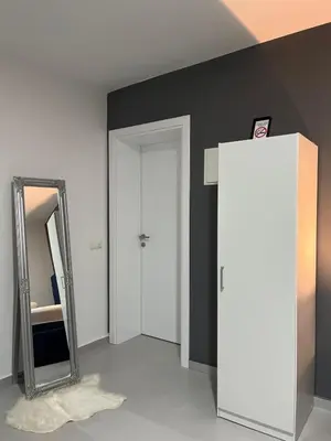 a room with a mirror and a white door at Apartments Indigo in Jajce