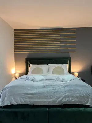 a bedroom with a bed with two pillows on it at Apartments Indigo in Jajce