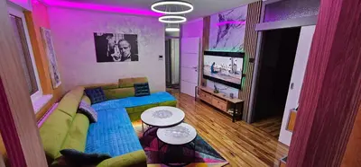 a living room with a couch and a flat screen tv at Smart Lux in Tuzla