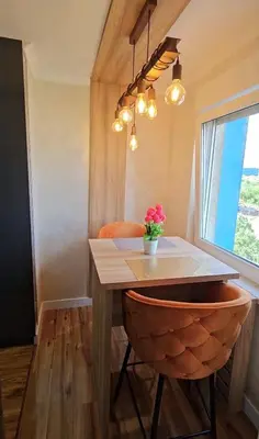 a dining room with a table and a chair with flowers at Smart Lux in Tuzla