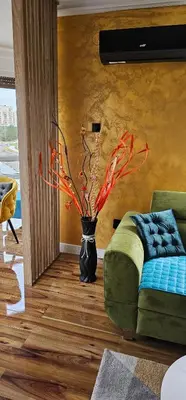 a living room with a vase with a plant in it at Smart Lux in Tuzla