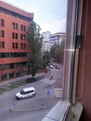 a view from a window of a street with a white car at Kiki in Banja Luka