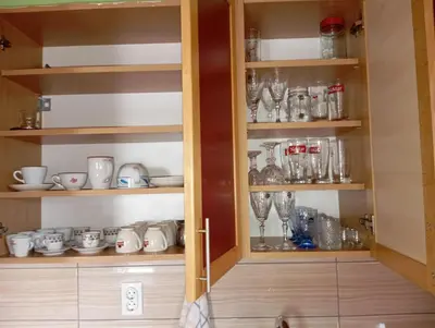 a cabinet filled with lots of glasses and cups at Kiki in Banja Luka