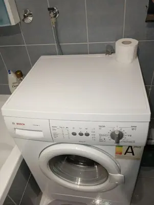 a washing machine in a bathroom with a toilet at Kiki in Banja Luka