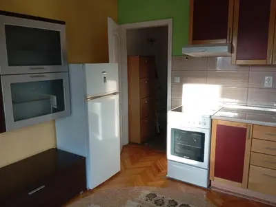 a kitchen with a white refrigerator and a stove at Kiki in Banja Luka