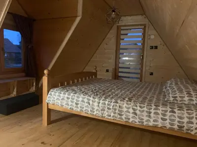 a bedroom with a bed in a attic at Suncev Brijeg in Banja Luka