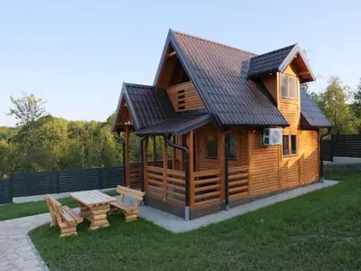 a log cabin with a picnic table and a bench at Suncev Brijeg in Banja Luka