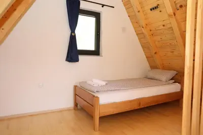 a bed in a room with a window at Bungalov La Repit in Šipovo